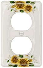 Load image into Gallery viewer, Kiln fired gloss white ceramic porcelain wall plate. One of a Kind fresh country Sunflower floral pattern on a square cover plate for bathroom, spa, or kitchen. high quality and durability. Stays white and gleaming for years to come. Duplex Receptacle cover plate configuration. Screws Included. Easy to clean with a damp cloth. Do not over tighten screws to avoid cracking the plate. Do not use automatic screwdrivers.